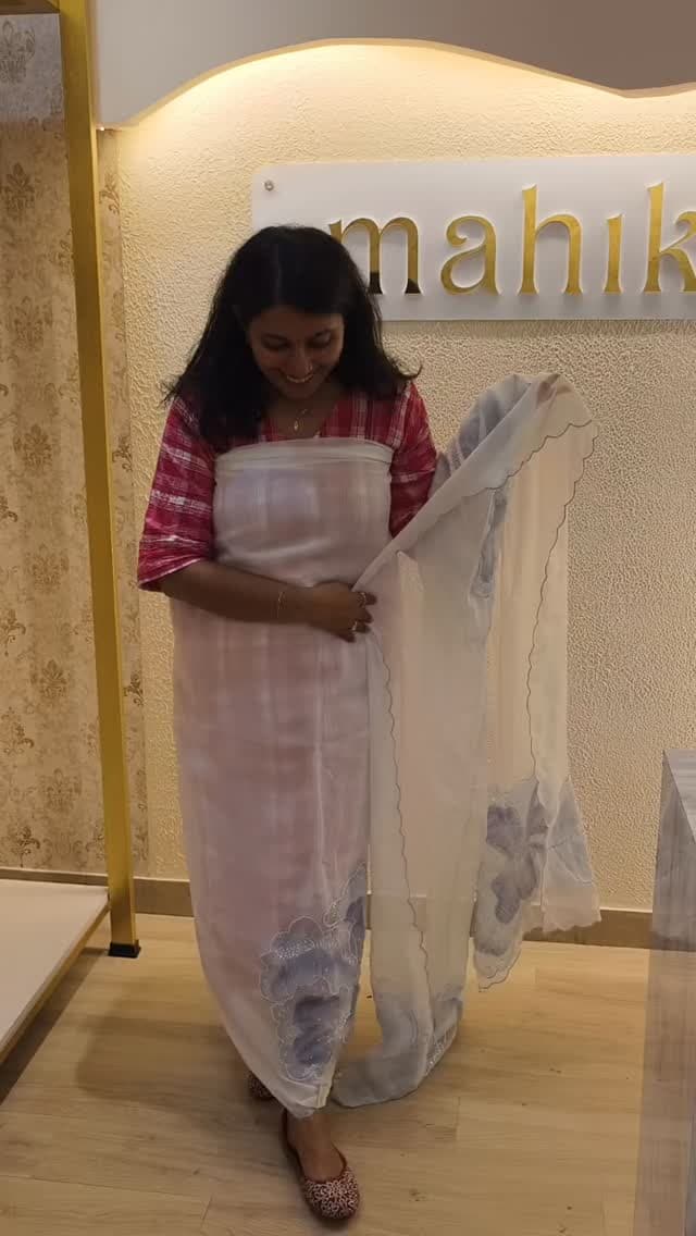 Inside the Mahika store, a muslin appliqué three-piece on display